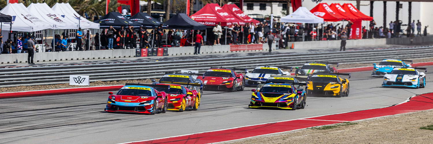 “Multiple brightly colored Ferrari race cars competing closely on a road course during a race, with spectators and team tents visible along the track in the background.”